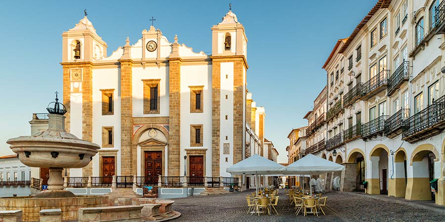 The large white stone Antao Church in the Giraldo Square of Evora. 